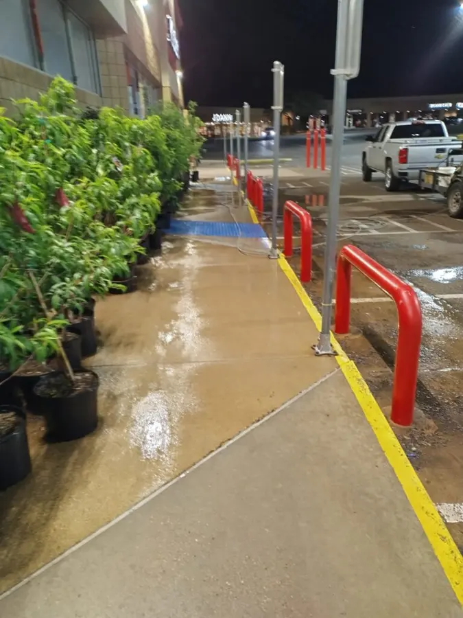 Freshly washed sidewalk and curb beside a garden center