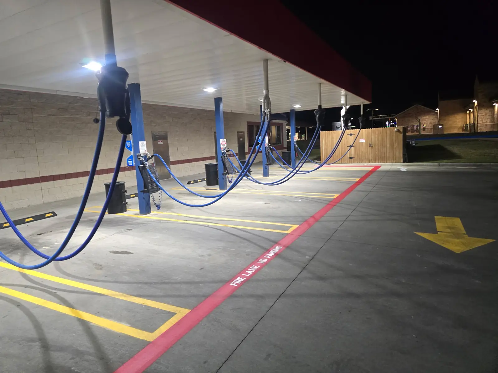 Fresh parking stall lines, a fire lane and an arrow at a car wash